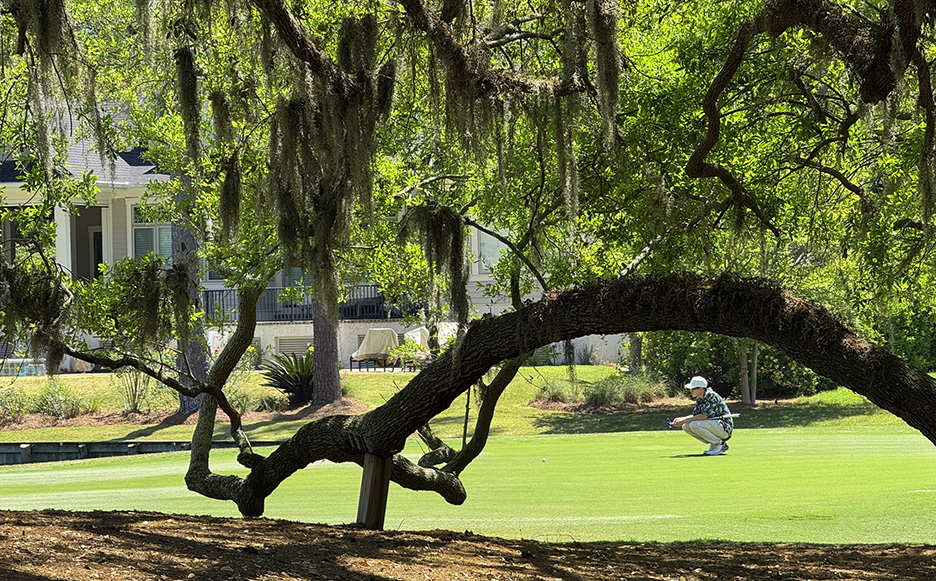 Reading the green for an important putt.